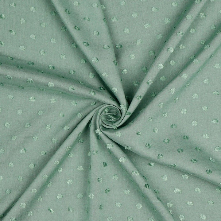 Viscose dobby textured spot polkadot dress fabric. Sage green and white