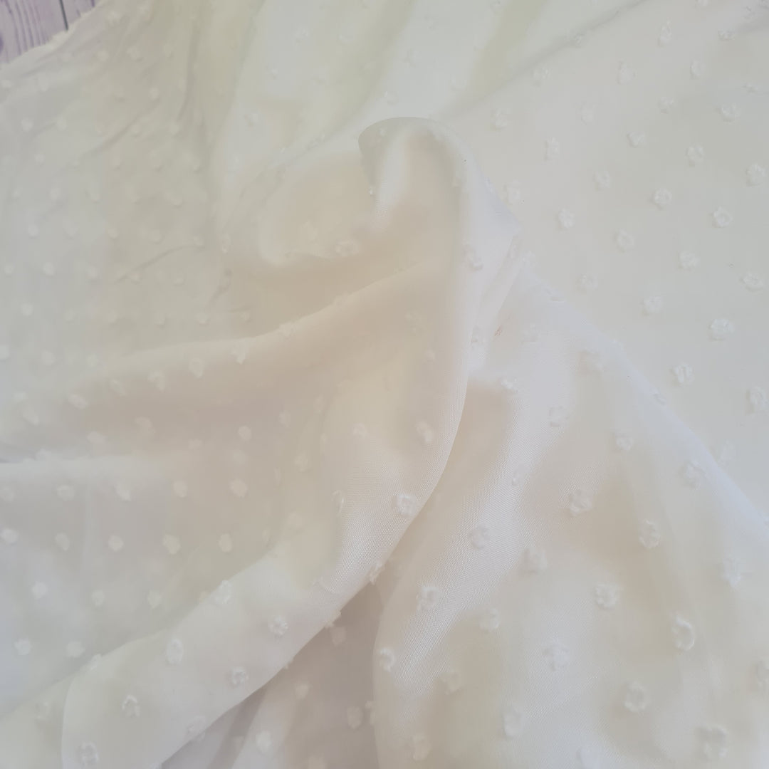 Viscose dobby textured spot polkadot dress fabric. Sage green and white